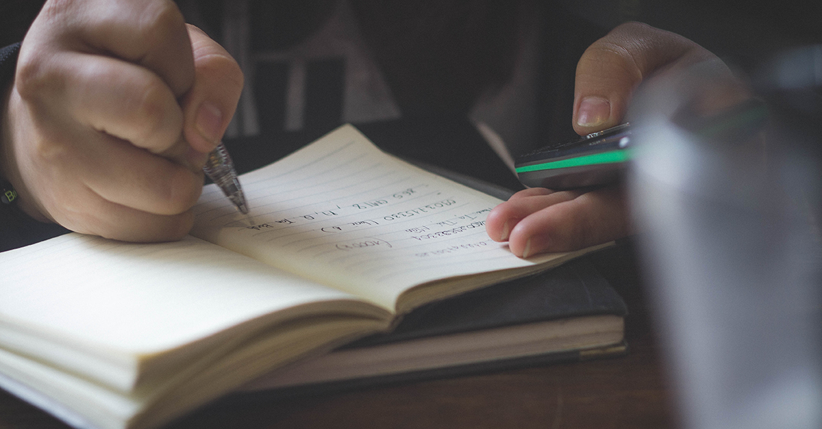 Person writing in notebook