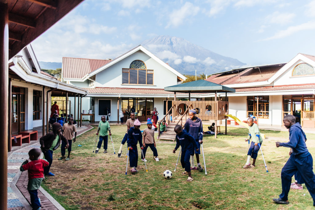Kids kick soccer ball in Tanzania while recovering from surgery