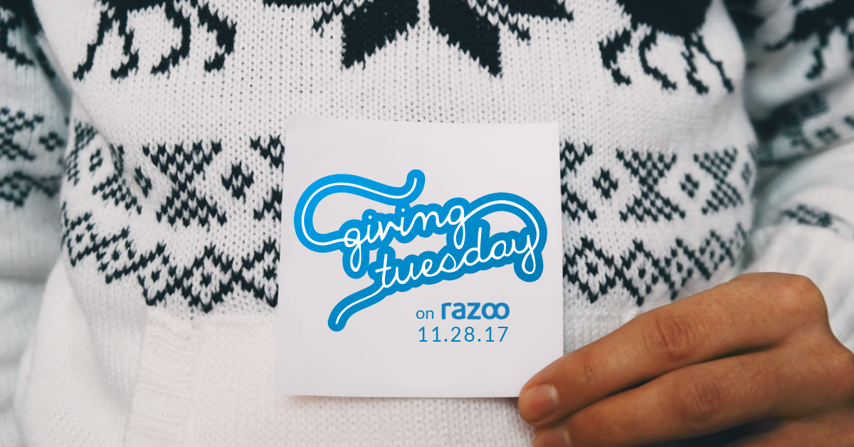 Hand holding card with #GivingTuesday logo and date on it